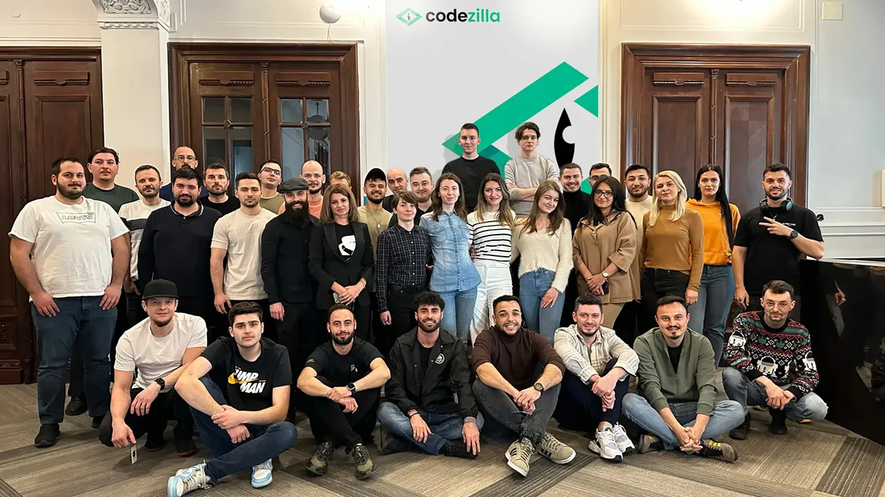 Large group of web developers and digital specialists posing in front of Codezilla headquarters