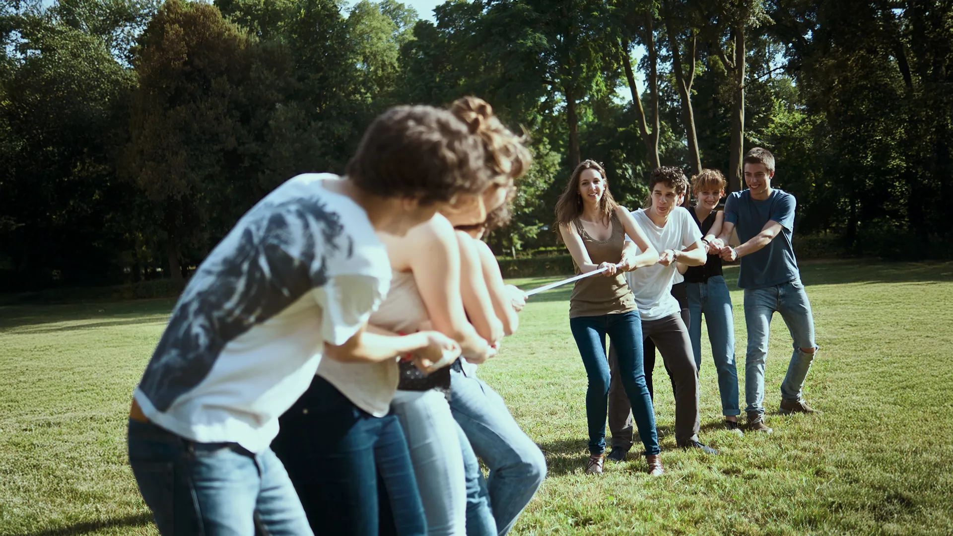 Membrii ai echipei participând la o activitate de team building în aer liber, bazată pe colaborare și spirit de echipă