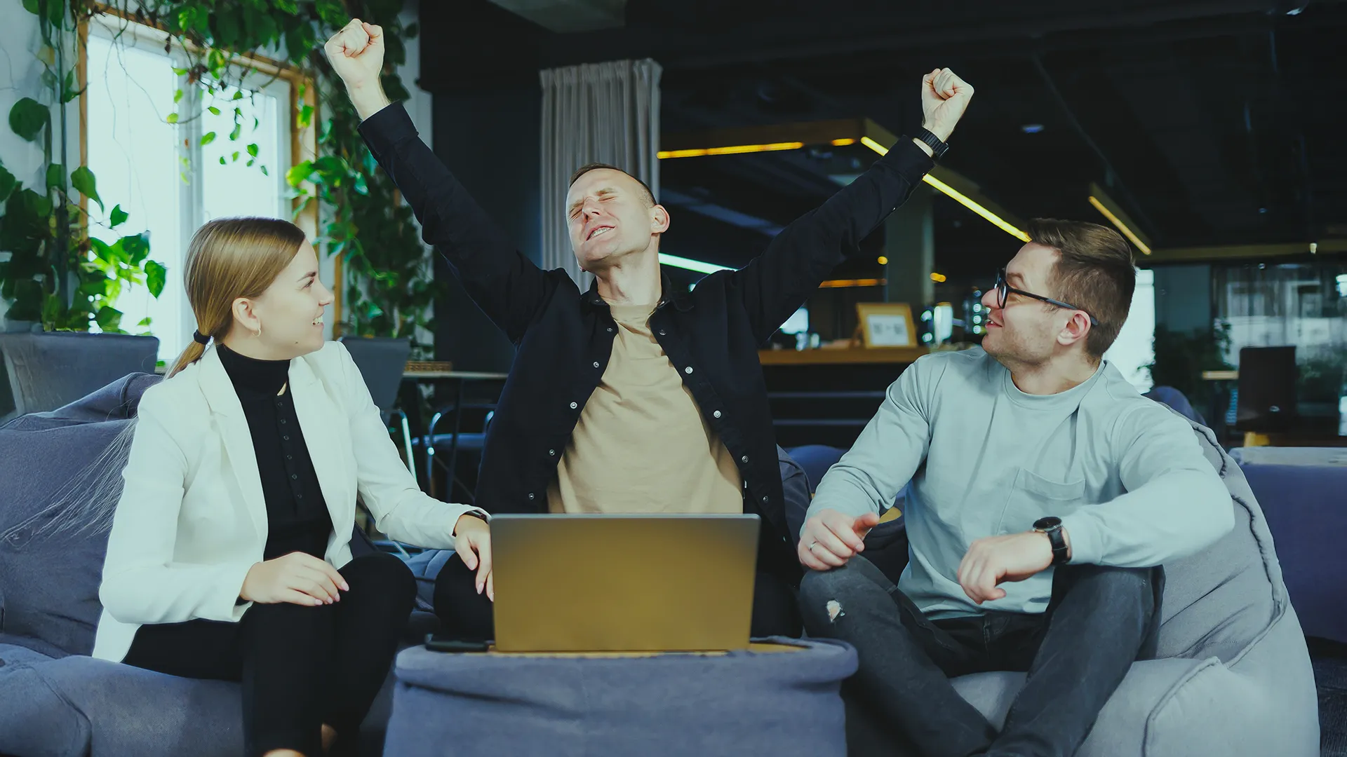 Team members in a modern office space during a relaxed moment that reflects an inspiring and friendly work environment